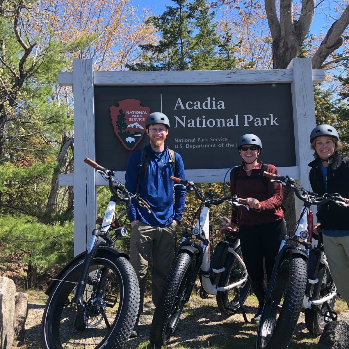 a group of people standing around a motorcycle