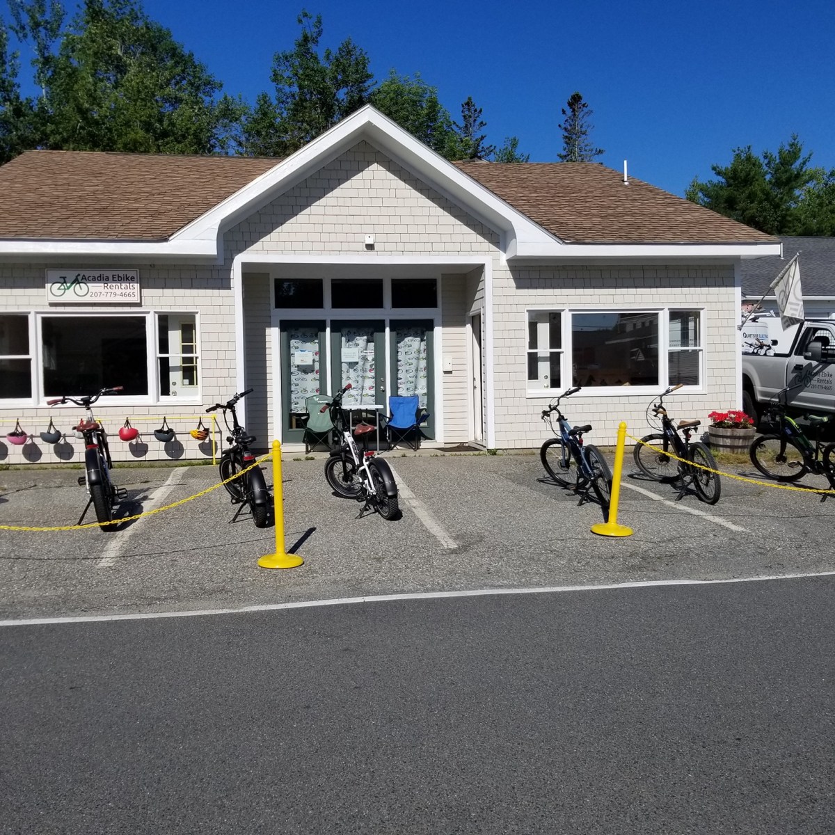 a group of people standing in a parking lot in front of a house