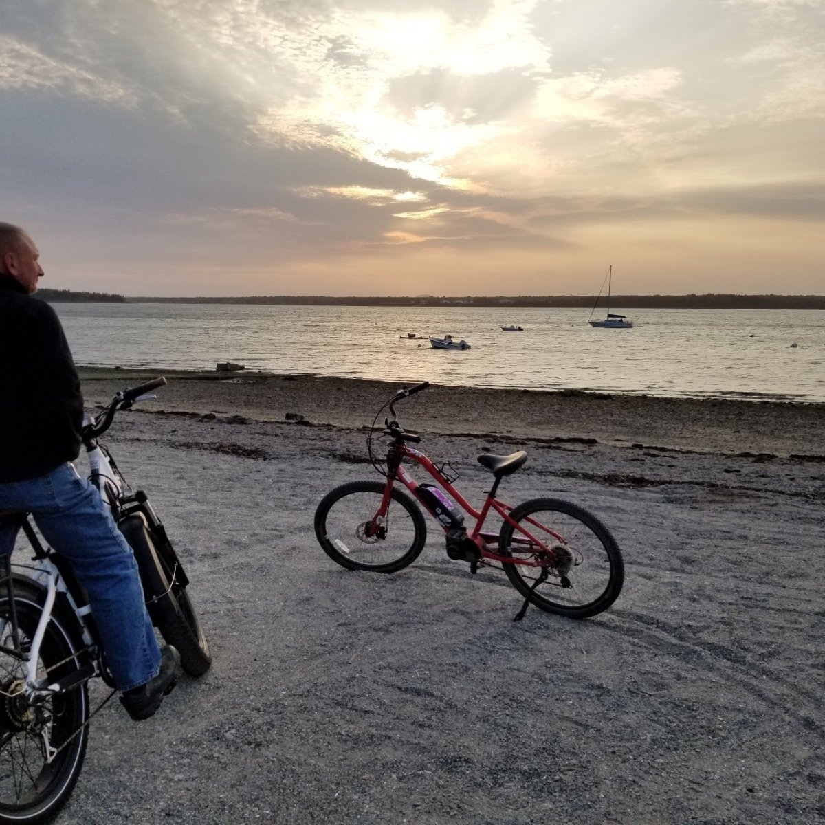 a man riding a bicycle next to a body of water